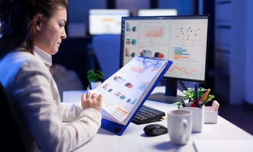 freelancer-woman-comparing-graphics-from-clipboard-with-grafics-from-computer-business-office_482257-5156